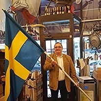 Stefan med Magiska Brödernas fana. Den levererades inte av Carl Gustav som till SMC utan kom med DHLs budbil till vår vinbutik på Östermalm.